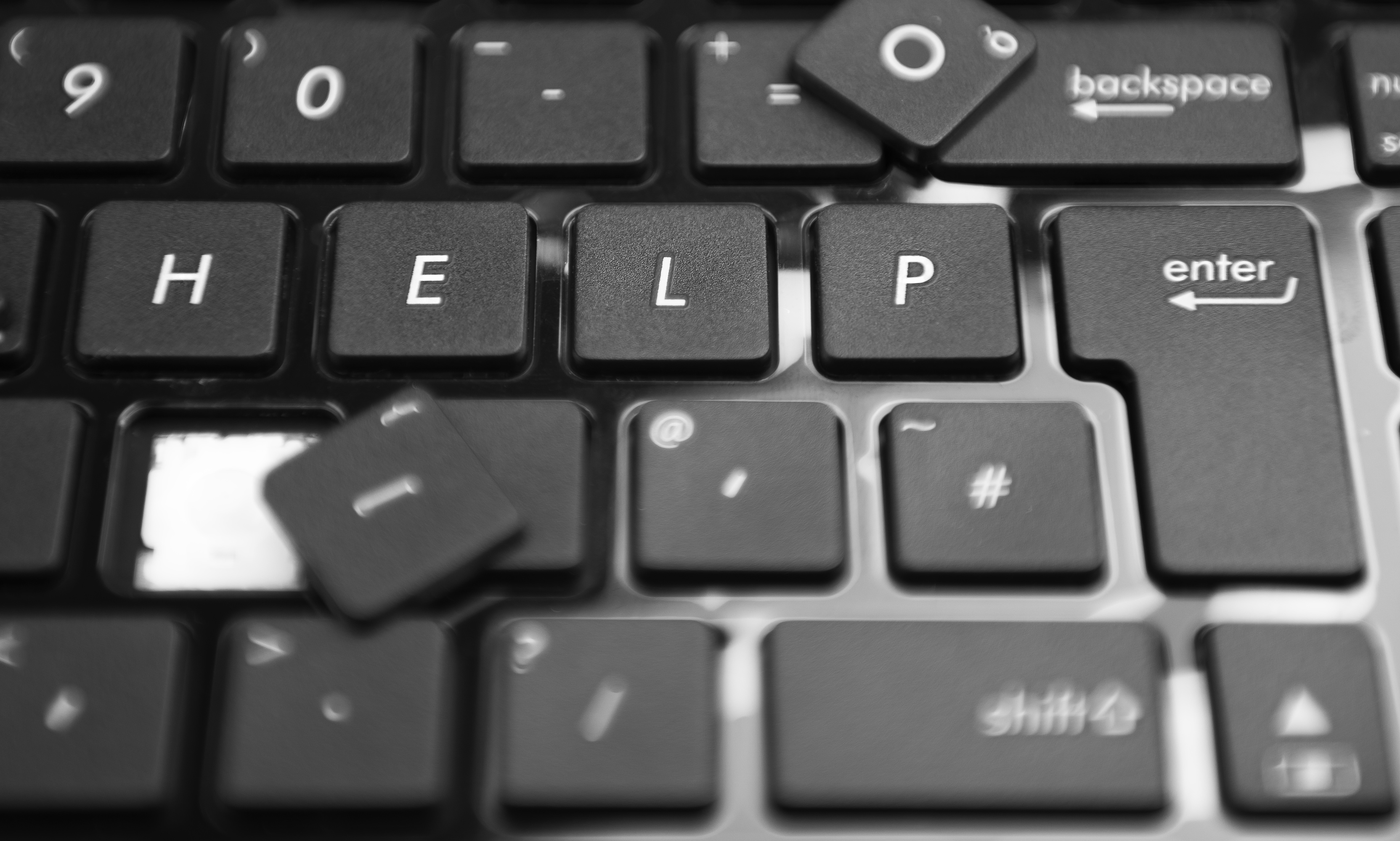 The word help on a laptop keyboard Photo closeup