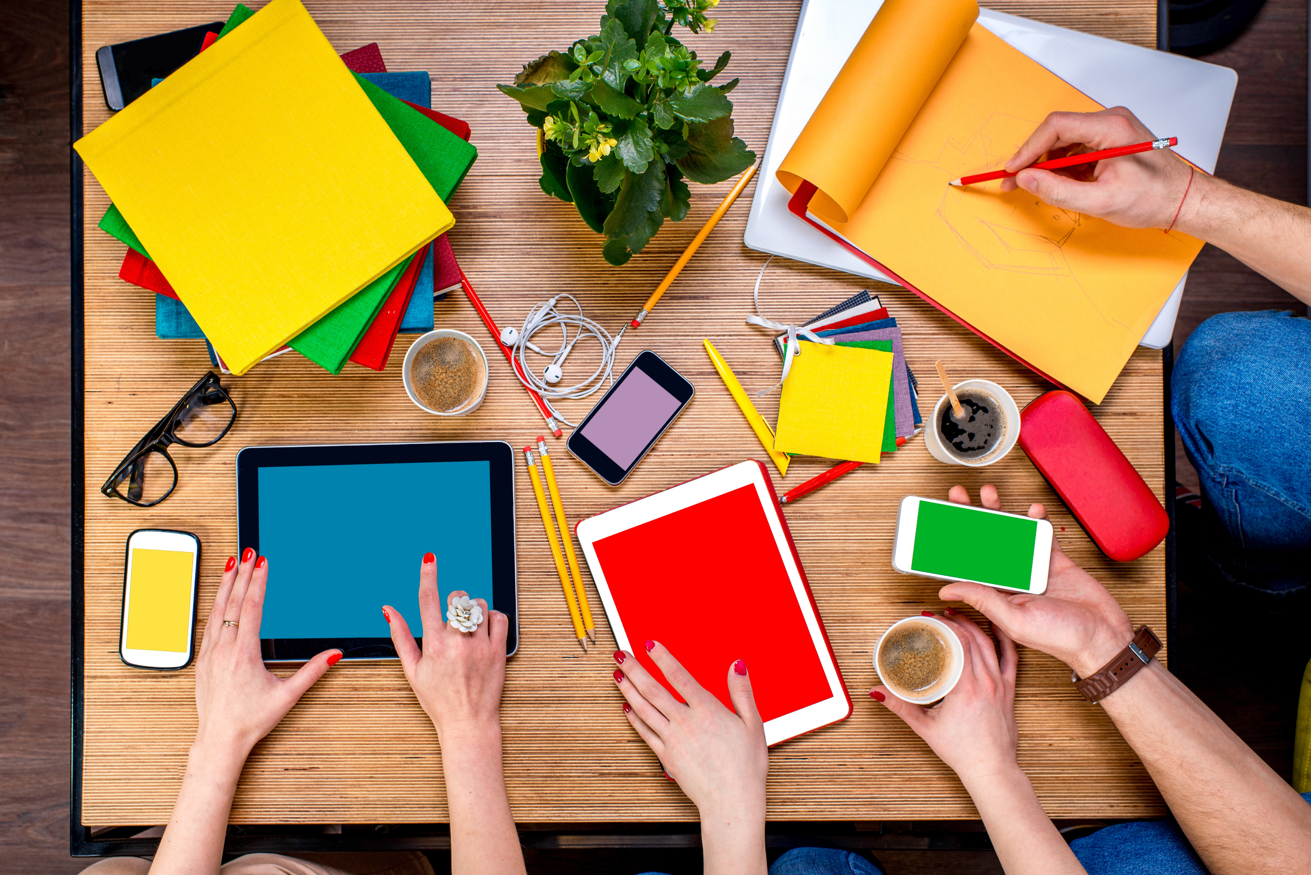 Working or studying with digital gadgets and different colorful stuff and coffee on the wooden table. Top view