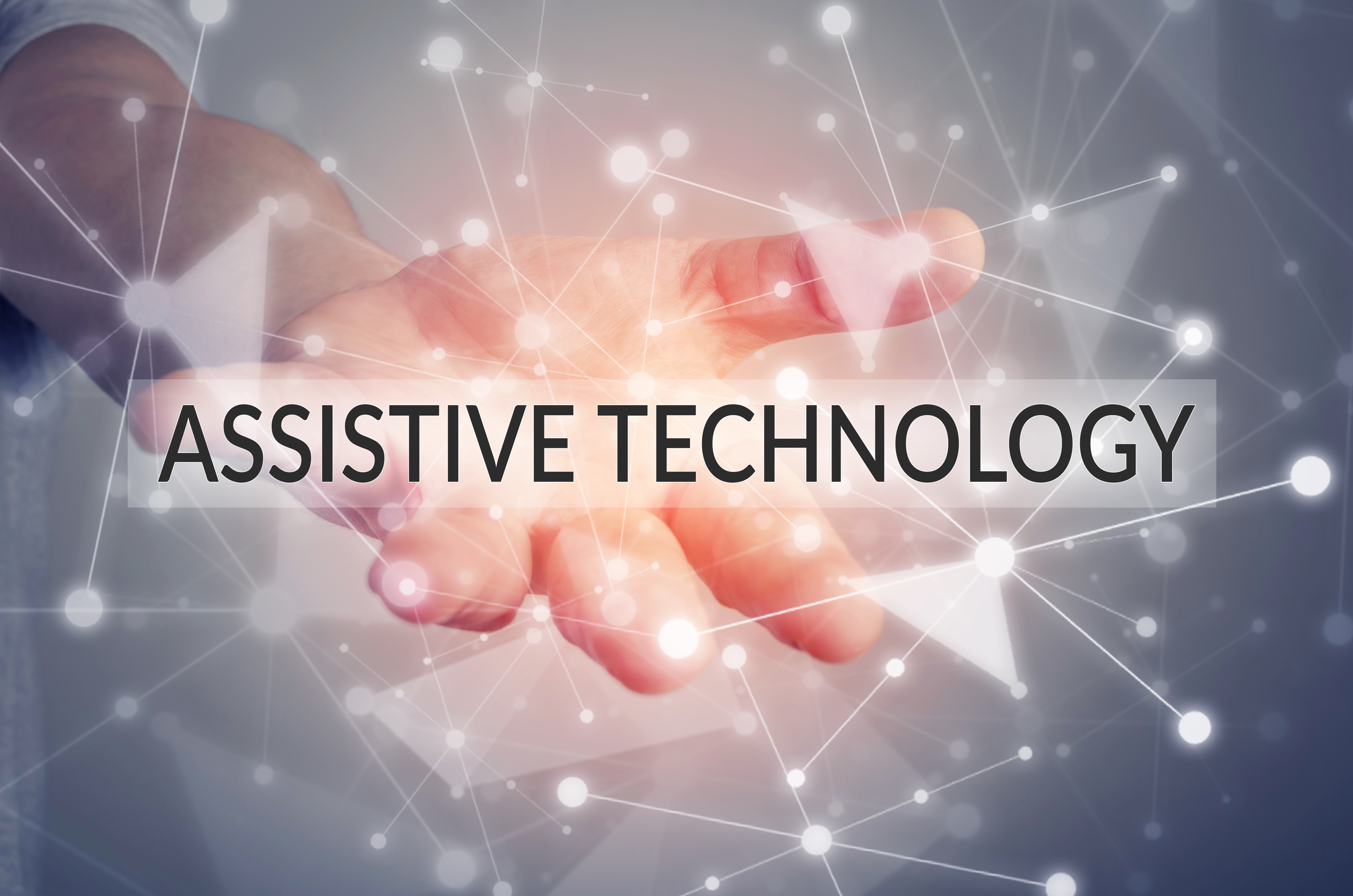 A hand reaching out to you with the words 'assistive technology' written over the top of the image.