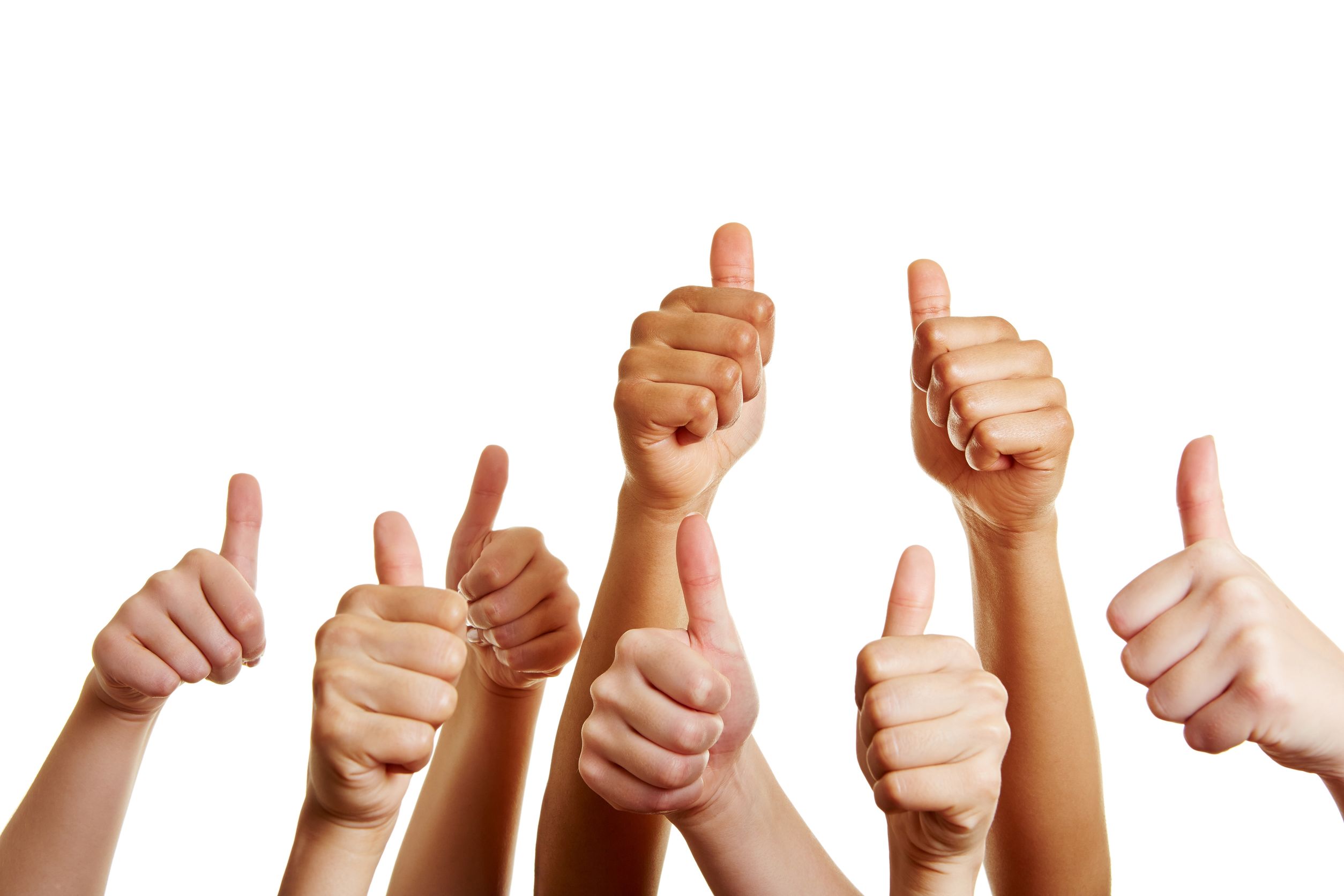 group of people holds many thumbs up and congratulates the winner
