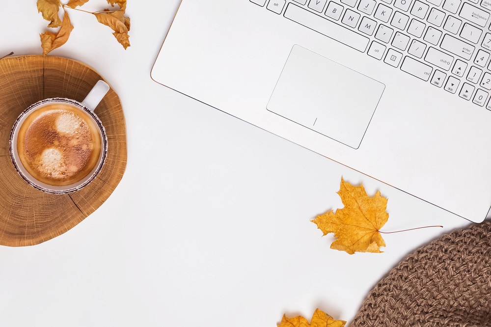 Laptop with a cup of coffee next to it