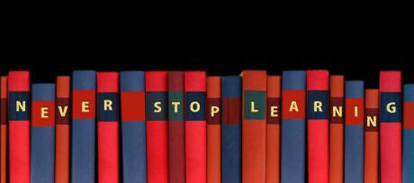 Books with 'never stop learning' written on their spines